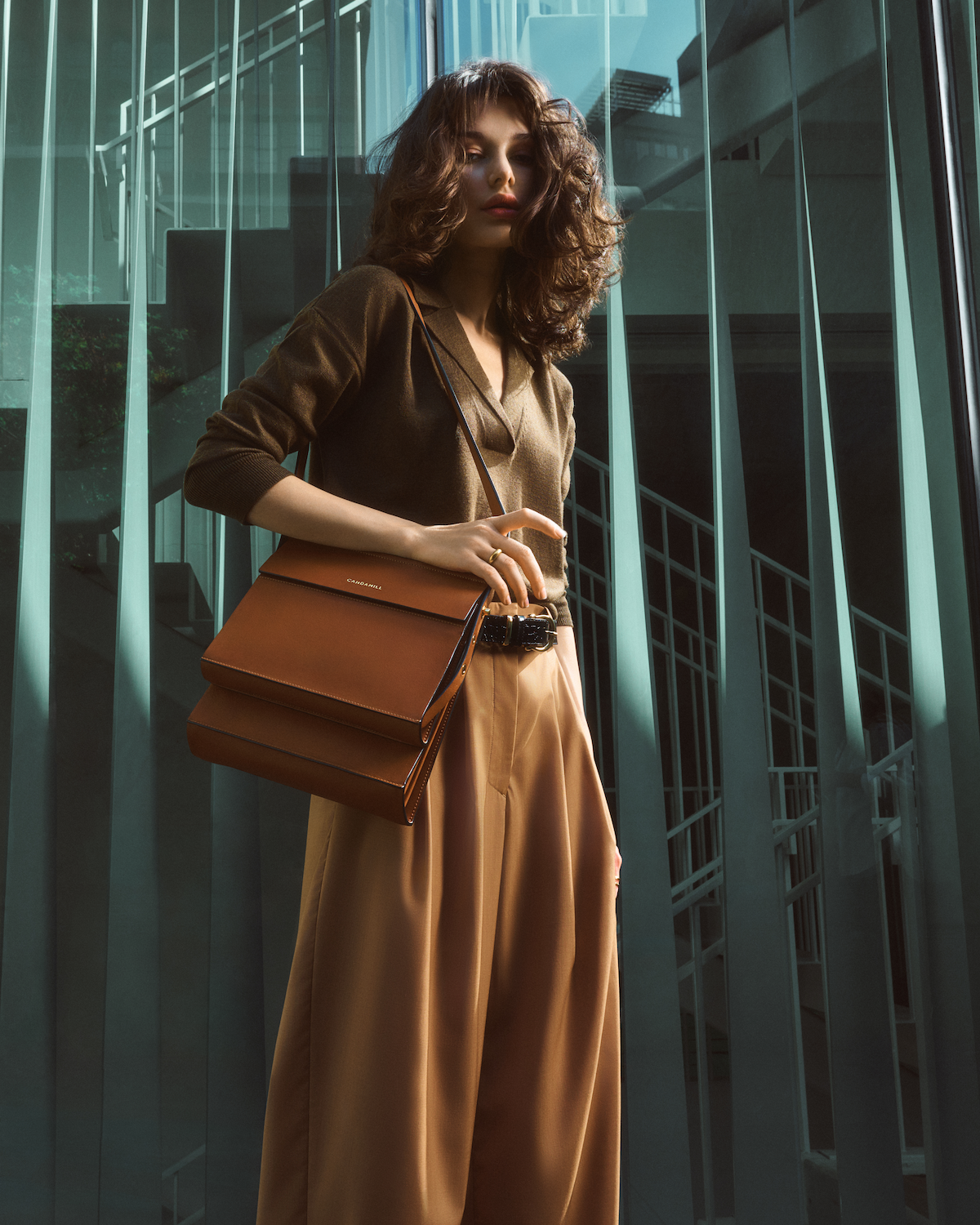 Model carrying the High Rise bag in Saddle leather across the body