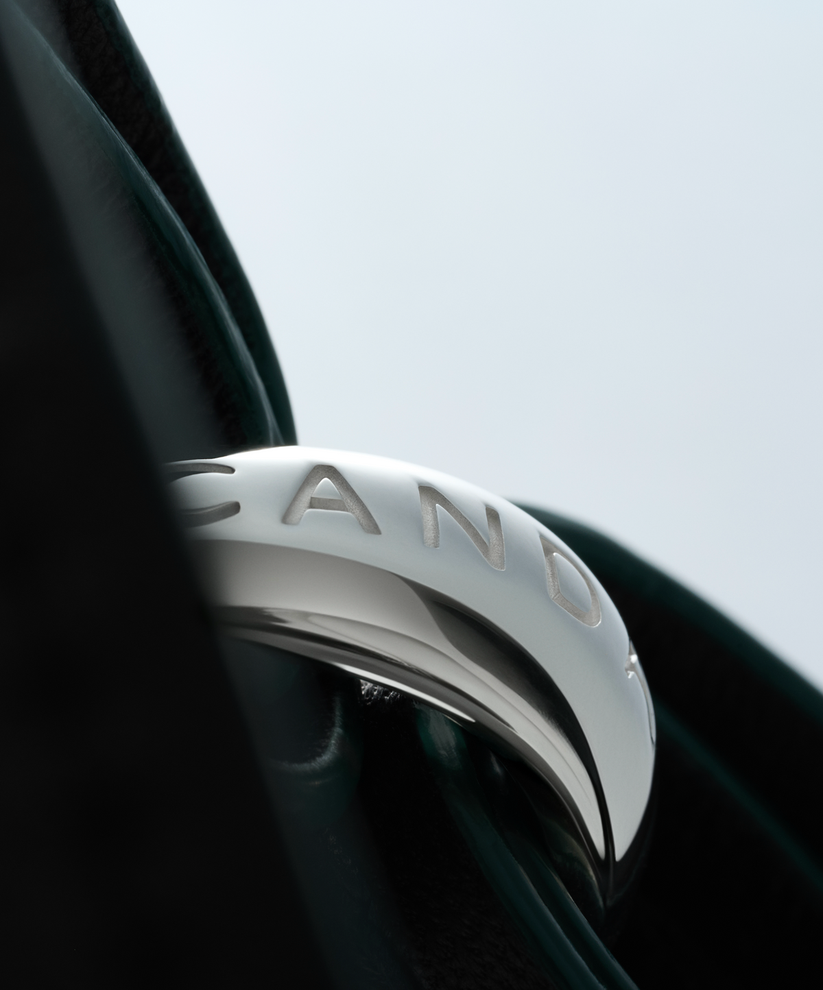 Close-up of The Collector tote's engraved Silver cuff and Black leather