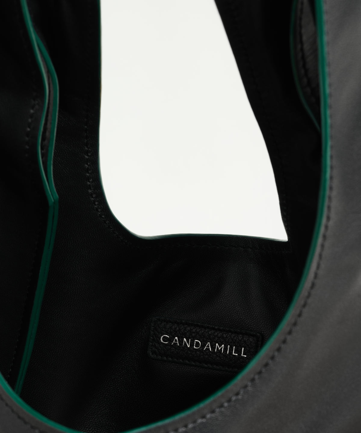 Interior detail of The Collector Silver tote showing the lining and Candamill label