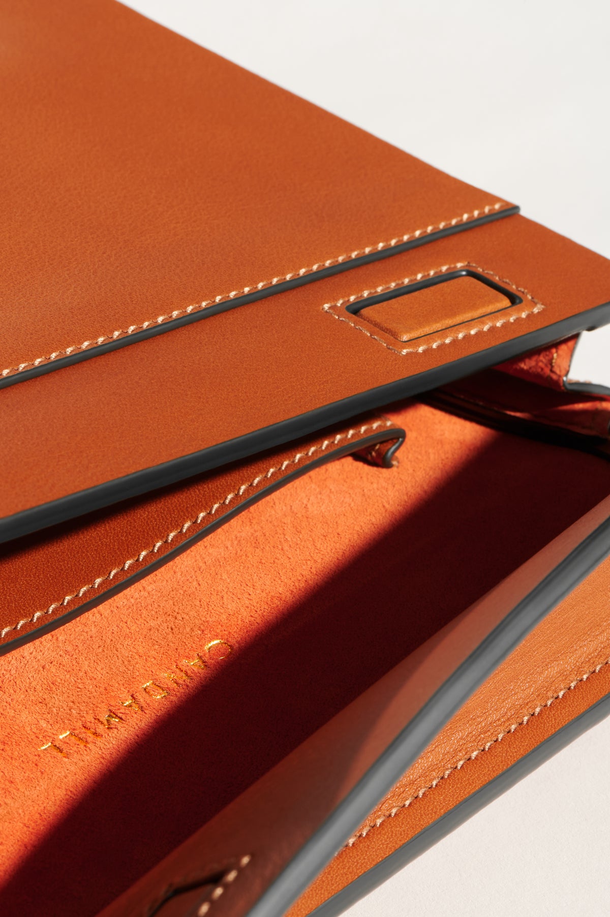 Close-up of the High Rise Saddle flap, stitching and compartment opening