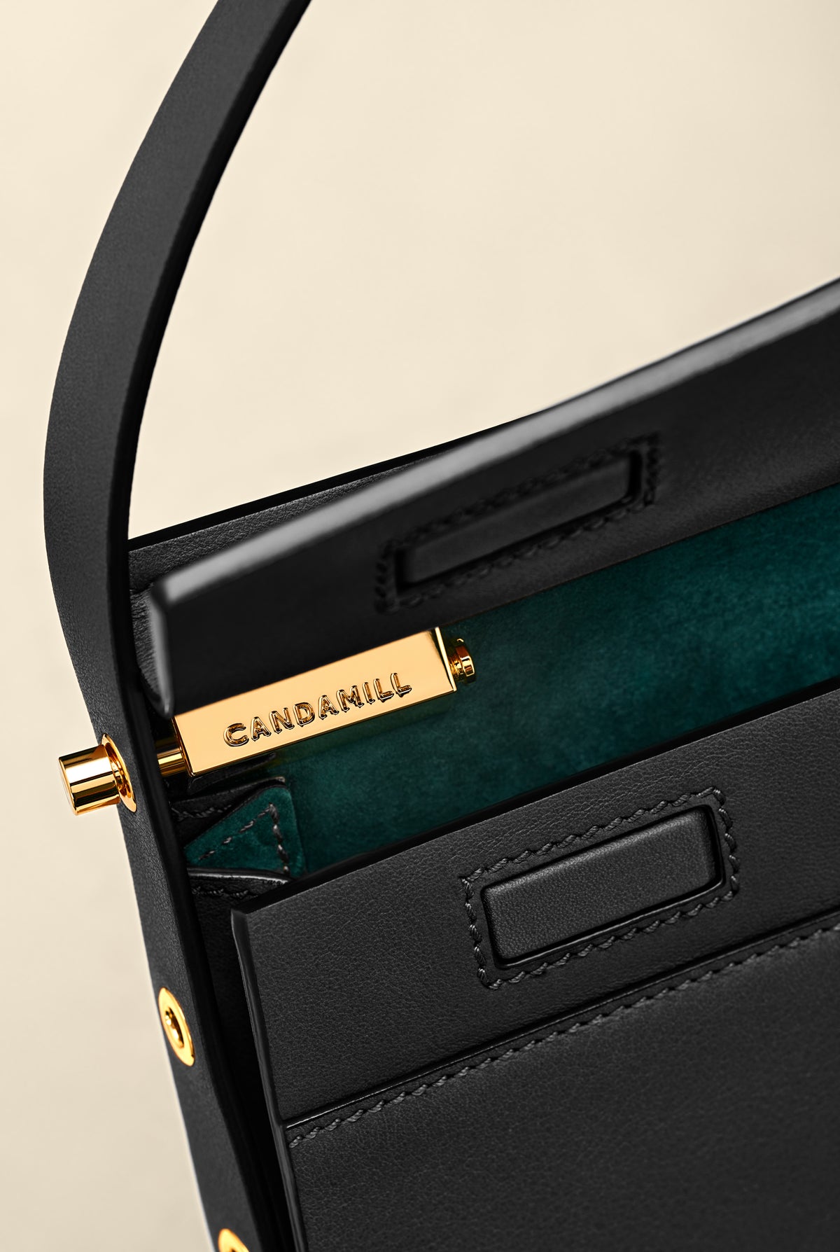 Low Rise in Black leather opened to show gold hardware and green suede lining