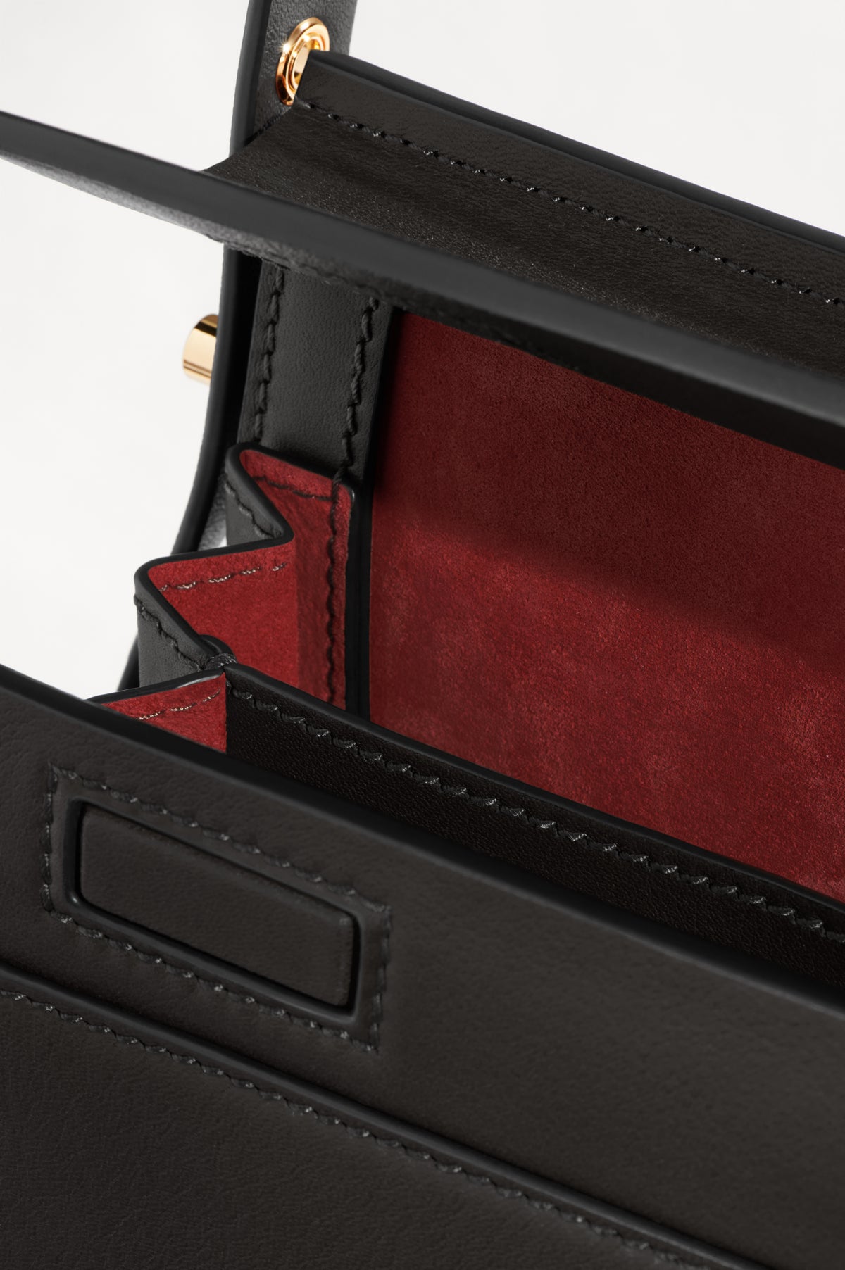 High Rise in Black leather with its compartments open, showing the contrasting lining and interior pocket