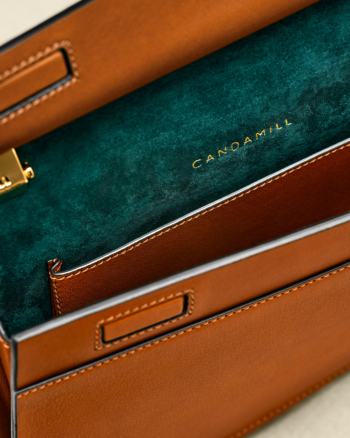 Close-up of the Low Rise Saddle interior, green suede lining and leather pocket