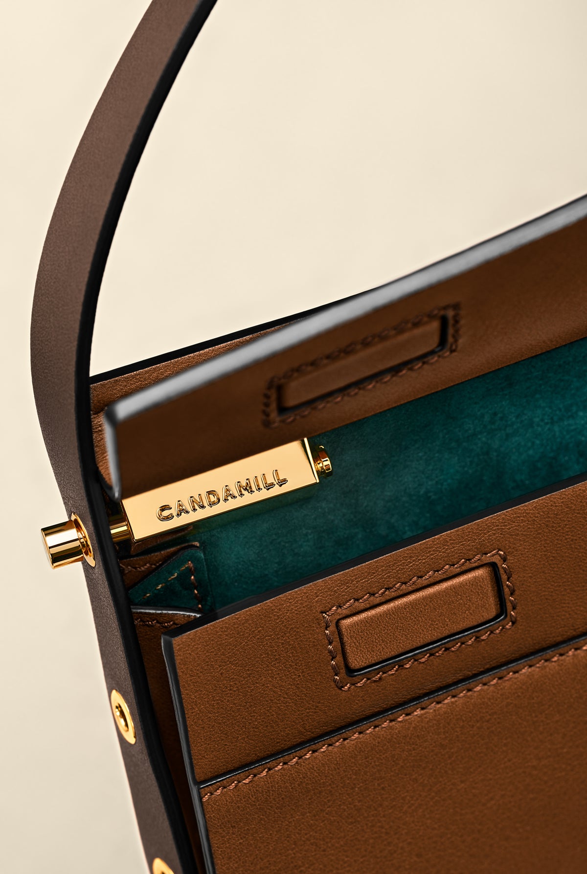 Low Rise in Cacao leather opened to show gold hardware and green suede lining