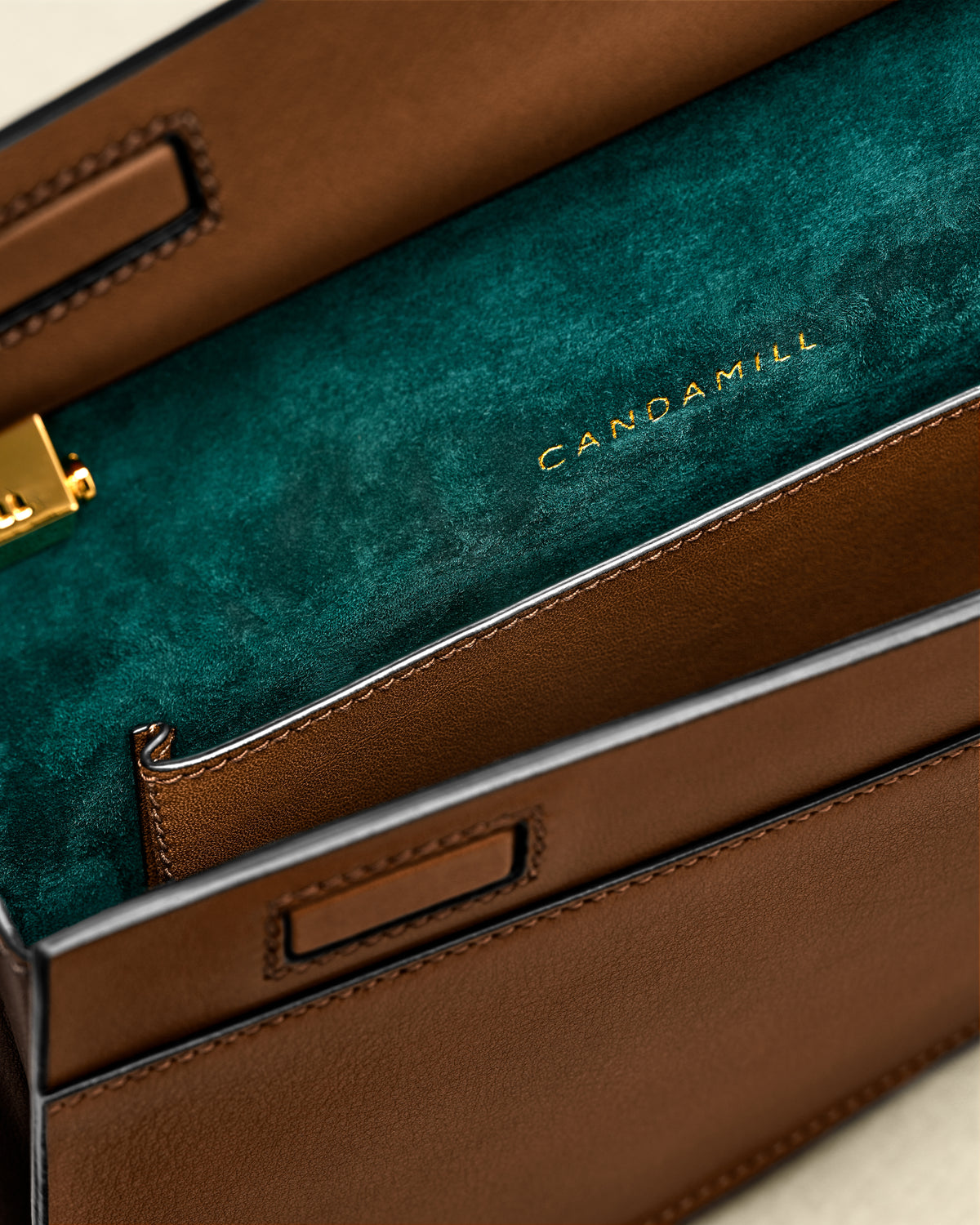 Close-up of the Low Rise Cacao interior, green suede lining and leather pocket